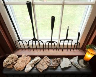 Vintage primitive hand-forged iron fishing spears, a large rock and mineral collection, and a vintage Andrea by Sadek amber and green tulip lamp