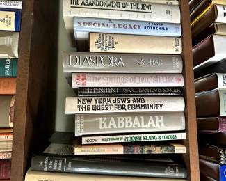 Two shelves of books on Judaism