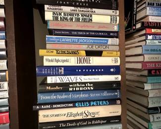 Books including A Rare Benedictine by Ellis Peters, The Stories of Elizabeth Spencer, and Head to Toe by Joe Orton