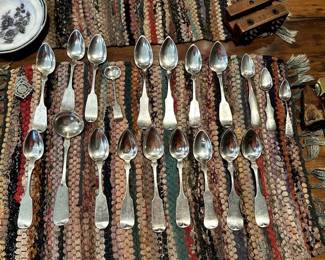A selection of antique silver spoons in various sizes - some American, some from England and Europe
