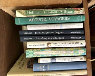 Books including Essential Tibetan Buddhism by Robert Thurman, and Early Spanish Manuscript Illumination by John Williams