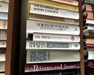 Two shelves of books on Judaism - Titles include The High Walls of Jerusalem, Encyclopedia of Jewish Concepts, Ancient Israel Myths & Legends, The Springs of Jewish Life, A Handbook for the Jewish Family, Diaspora, Coat of Many Colors, A Collector's Guide to Judaica, A Dictionary of Yiddish Slang & Idioms, New York Jews And The Quest for Community, and many more books