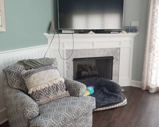 Cozy armchair; fireplace; wall mounted flat screen TV
