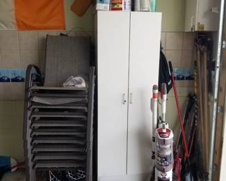Tall storage cabinet; patio chairs; vacuum cleaner