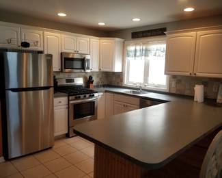 Rental side features updated cabinetry and stainless steel appliances
