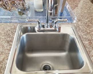 Kitchen island has a bar sink