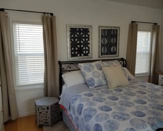 Wrought iron king bed; curtains; accent table