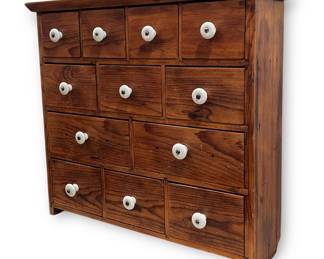 A Primitive Multi Drawer Wall Cabinet