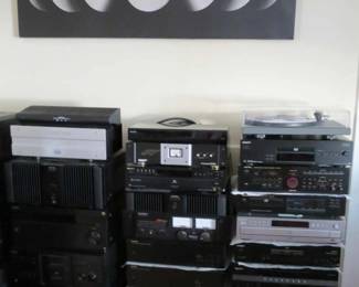 stacks of vintage and modern audio equipment