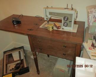 Singer sewing machine in cabinet