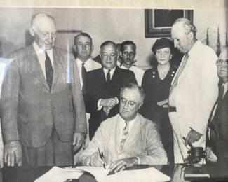 President Roosevelt signing Social Security Act in 1935.