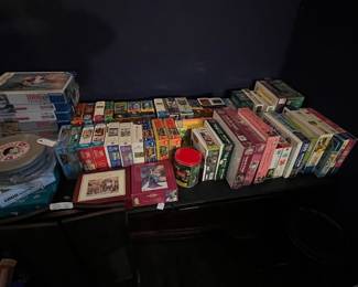 A whole table full of puzzles- some are unopened!!