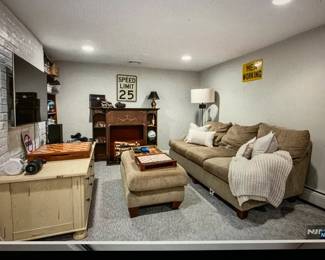 Tan couch with matching ottoman (asking $200); faux fireplace mantel (asking $50); cabinet with drawers under the TV (asking $25).