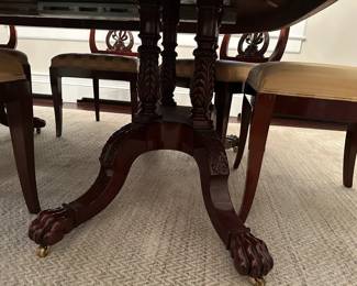 Classing wooden dining table - close up of table legs.