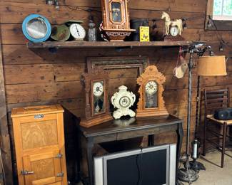 Wooden ice chest. Lamps gas cans and antique clocks