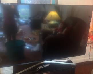 65 inch Samsung TV and black TV stand