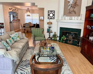 soft sage green sofa, antique upholstered arm chair