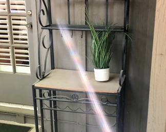 One of two available bakers racks or plant stands