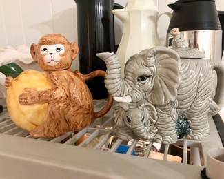 Animal teapot collection including:elephant, monkey, and cats.