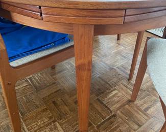 Another view of the MCM round table: legs and the extensions that slide underneath. When pulled out and opened extends the round table