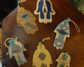 Clay Hamsas (palm shaped amulets with an eye symbol for protection) In othewords, it brings good fortune and wards off evil.