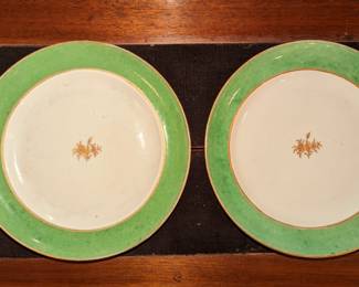 Chinese made for export 17th century . Pair of chargers apple green with a sprig and gold in the center. One has a hairline crack.