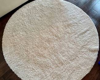 Round area rug neutral in color