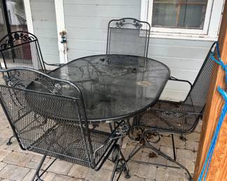 Glass top Wrought Iron table and 4 rocking chairs
