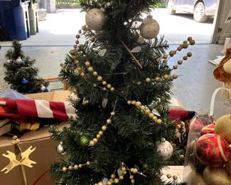We have two fully decorated Christmas trees, about 3' tall and another large tree still in the box...about 7' tall!  