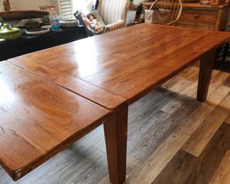 Dining table w 2 extension that slide into both ends (shown with 1 end in)