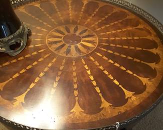 Close up of Theodore Alexander table top showing the intricate inlay of various woods