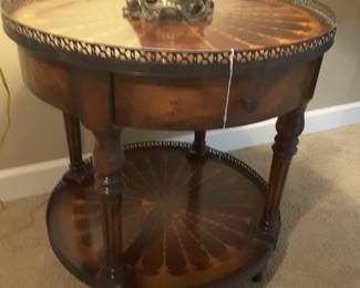 Beautiful side table by Theodore alexander. Features marquetry inlay top with vintage brass fender around the top and bottom edges..excellent condition