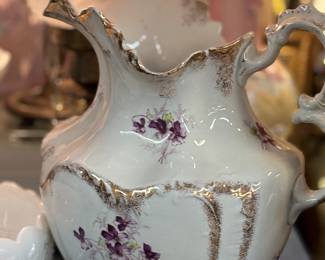 Porcelain white pitcher with violet design.