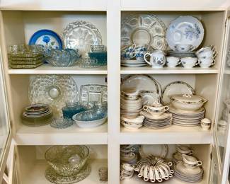 LARGE LAUNDRY ROOM WITH LOTS OF BUILT IN CABINETS FULL OF MORE CHINA AND GLASSWARE.
