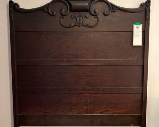 C43 - $125. Full size antique Bed frame. Headboard measures 55" wide x 76" tall. We also have the rails and footboard. Beautiful solid wood construction and carving.
