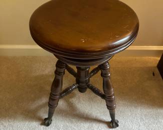 C26 - $45. Adjustable Piano stool with glass ball feet.