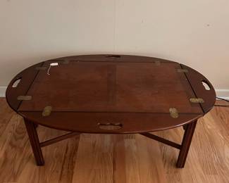 C52 - $65. Butler Tray Style Coffee Table. Measures 46" long x 31.5" wide x 17.25" tall. Very good vintage condition - (missing one tiny veneer piece see photo)