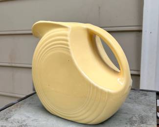 C99 - $25. Yellow Fiesta Disc Pitcher. Large 67 oz size. Measures 8" x 7.35" x 4.75" wide.
