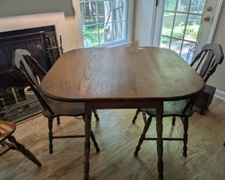 C25 - $80. Wooden Drop Leaf Table. Measures 40" x 35.5" x 29.25" tall. (Has 2 chairs with matching design. Included if you want them but they have been stored in the attic so the finish isn't as nice as the table)