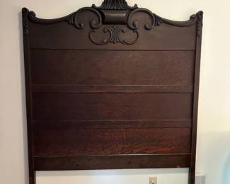 C43 - $125. Full size antique Bed frame. Headboard measures 55" wide x 76" tall. We also have the rails and footboard. Beautiful solid wood construction and carving.