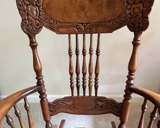 C123 - $125. Ornate Carved Wooden Rocking Chair. Measures 39" tall. 16" Floor to Seat.