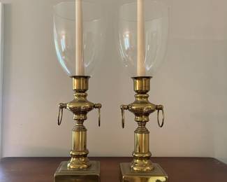 C111 - $30. Brass Candle Holders measures 10" tall. 17" tall with glass globes.