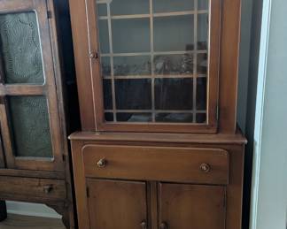C34 - $125. Old Town Maple China Cabinet. Vintage - Solid Wood. Smaller size. Measures 32" wide x 15" deep x 62" tall. Doors work well - drawer is slightly sticky. One knob is broken and has minor scratching.