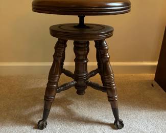C26 - $45. Adjustable Piano stool with glass ball feet.