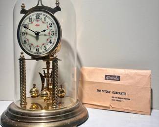 C30 - $40. Kundo 400 day Clock. Measures 11.5" tall x 7" wide. Has original key & paperwork in envelope.