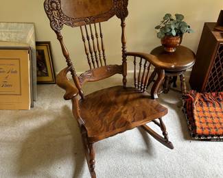 C123 - $125. Ornate Carved Wooden Rocking Chair. Measures 39" tall. 16" Floor to Seat.