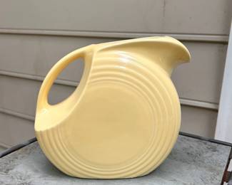 C99 - $25. Yellow Fiesta Disc Pitcher. Large 67 oz size. Measures 8" x 7.35" x 4.75" wide.