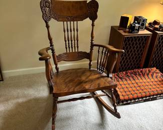 C123 - $125. Ornate Carved Wooden Rocking Chair. Measures 39" tall. 16" Floor to Seat.