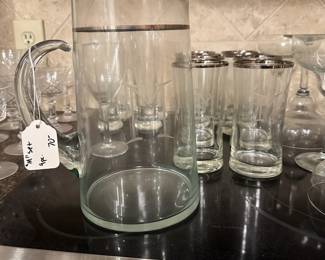 B123 - $70. Pitcher & 8 Glasses. Monogrammed with an "M". Silver Banded.