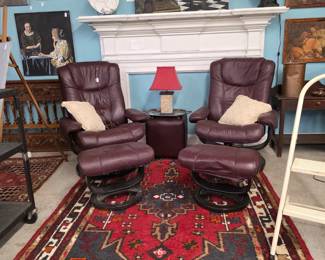 Leather chairs and ottomans, rug, art